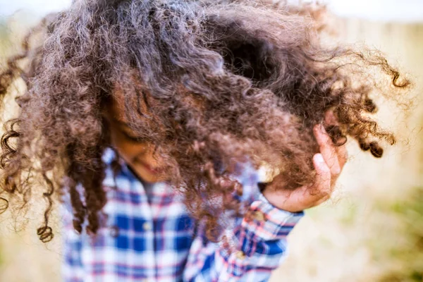 Afrikanerin im karierten Hemd draußen auf dem Feld. — Stockfoto