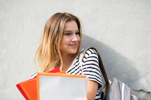 Beautiful teenage student posing in front of university. — Stock Photo, Image