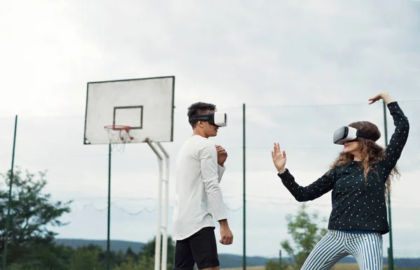 Attractive teenagers on playground with VR glasses. — Stock Photo, Image