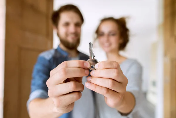 Pareja con una llave mudándose a su nueva casa . — Foto de Stock