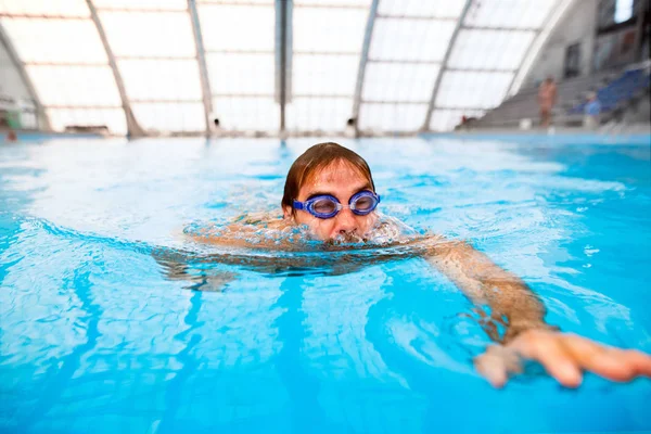 Man swimming in an indoor swimming pool. — Stock Photo, Image
