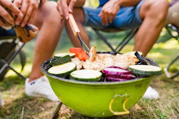 Onherkenbaar tieners koken van groenten op barbecue grill. — Stockfoto