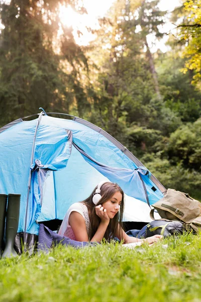 Tizenéves lány előtt sátor camping-erdő. — Stock Fotó