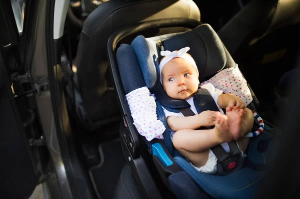 Little baby fastened with security belt in safety car seat. — Stock Photo, Image