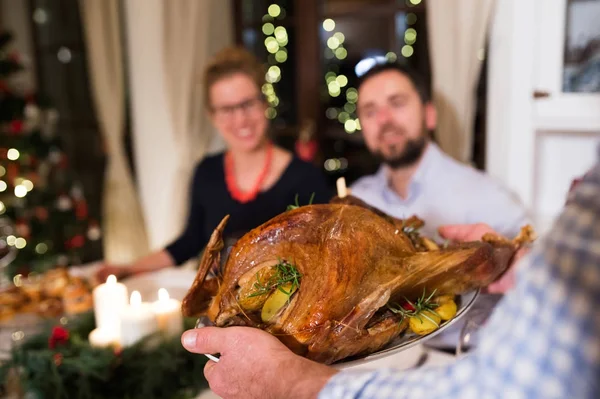 Family celebrating Christmas. Roasted turkey on tray. — Stock Photo, Image