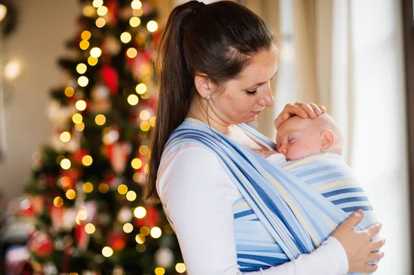 Młoda kobieta z baby boy w okresie Bożego Narodzenia. — Zdjęcie stockowe