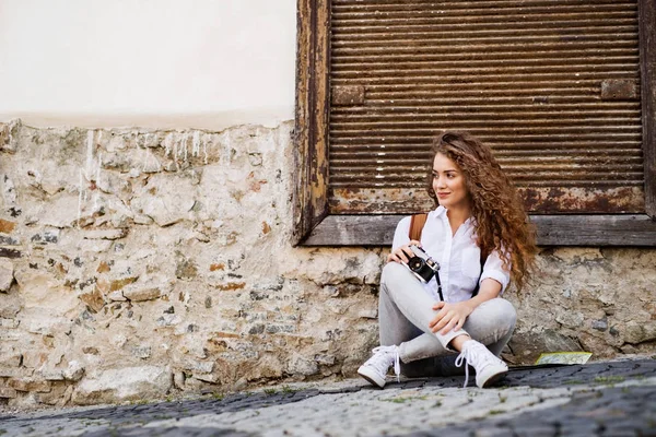 Schöne junge Touristin mit Kamera in der Altstadt. — Stockfoto