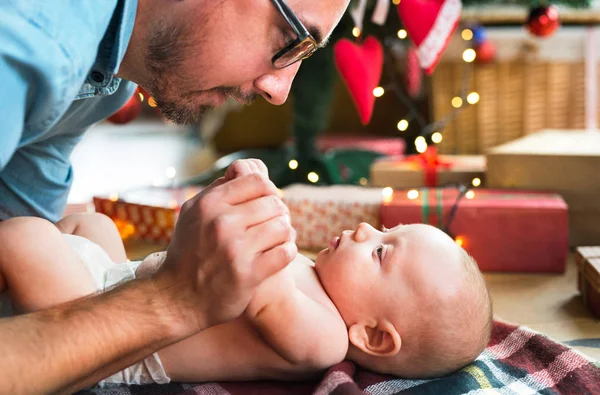 Bebek çocuk Noel ağacı önünde babasıyla.