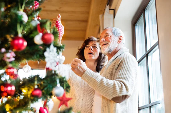 Senior couple décoration arbre de Noël à la maison . — Photo