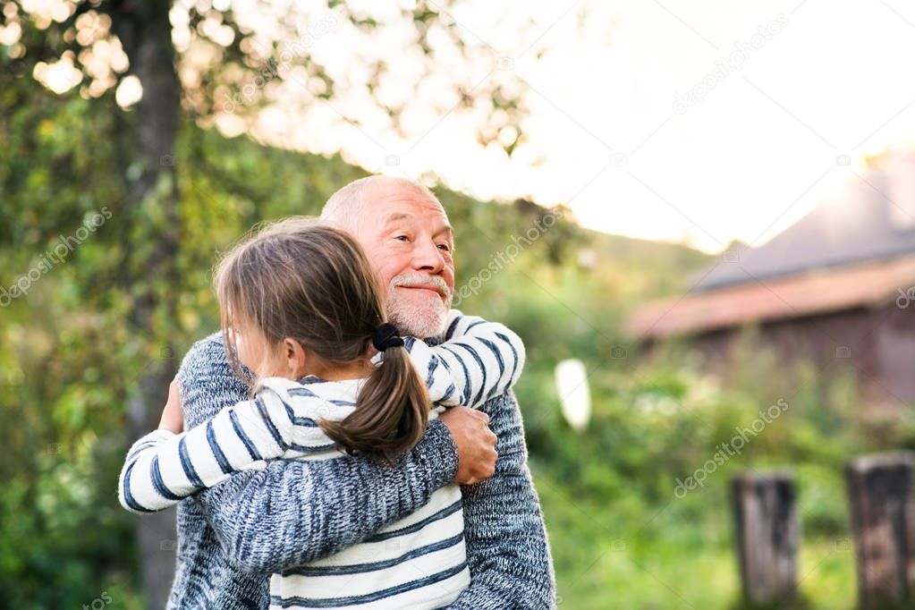 Grandfather giving his grandaughter a hug.