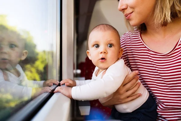 Jeune mère voyageant avec bébé en train . — Photo