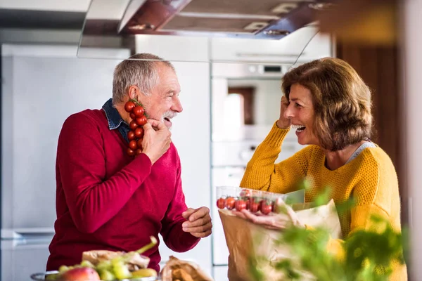 Couple de personnes âgées préparant la nourriture dans la cuisine. — Photo