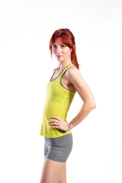 Attractive young fitness woman in green tank top. Studio shot. — Stock Photo, Image