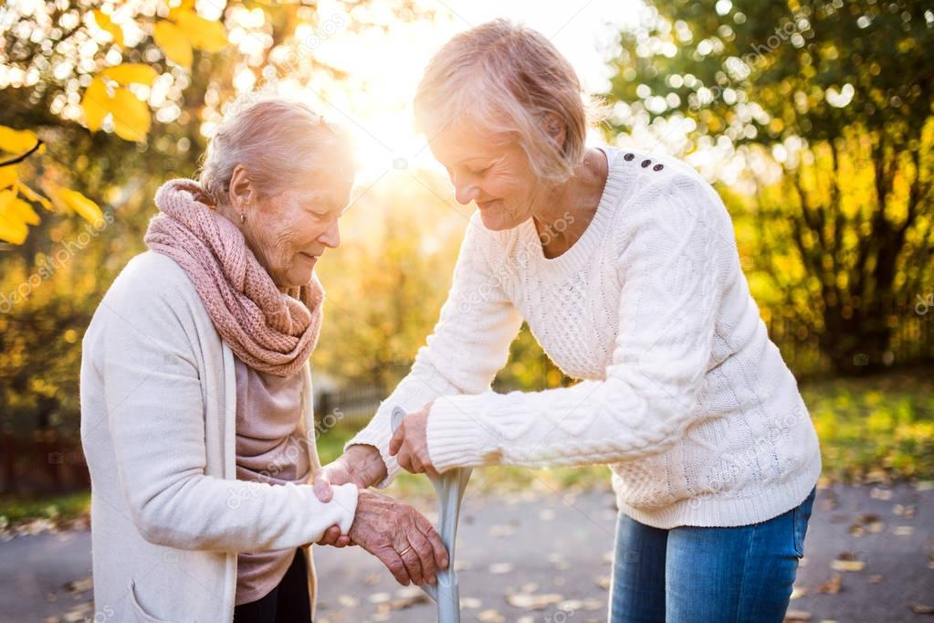 Senior women on a walk in autumn nature.