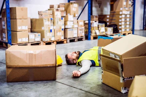 Warehouse worker after an accident in a warehouse. — Stock Photo, Image