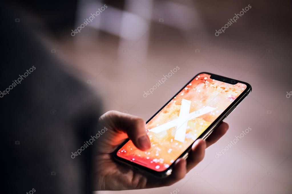 NOVA BANA, SLOVAKIA - NOV 28, 2017: A hand holding a new Apple iPhone X smartphone.