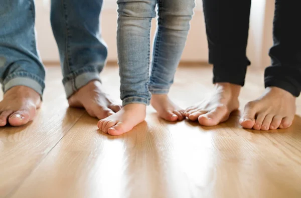 Beautiful young family. Bare feet of mother, father and daughter — Stock Photo, Image
