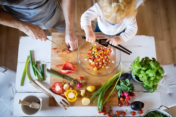 Young father with a toddler boy cooking. — Stock Photo, Image