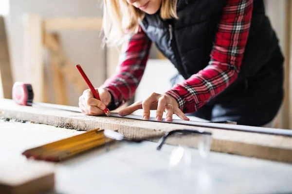 Young woman worker in the carpenter workroom. — Stock Photo, Image