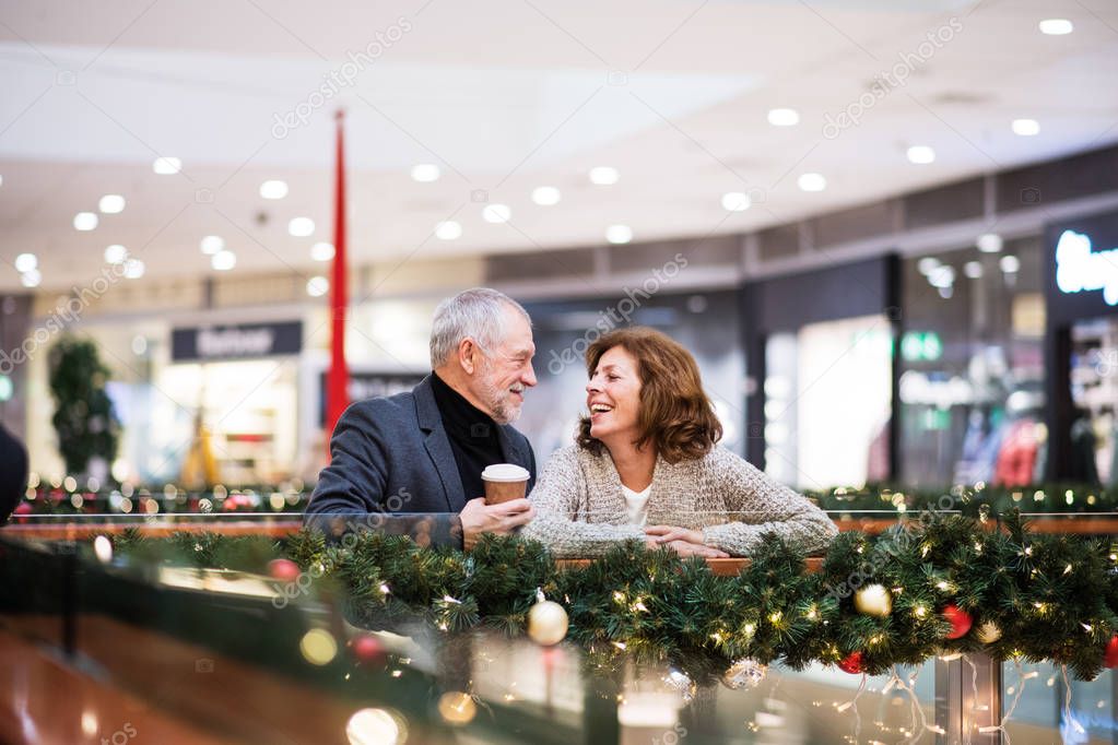 Senior couple doing Christmas shopping.