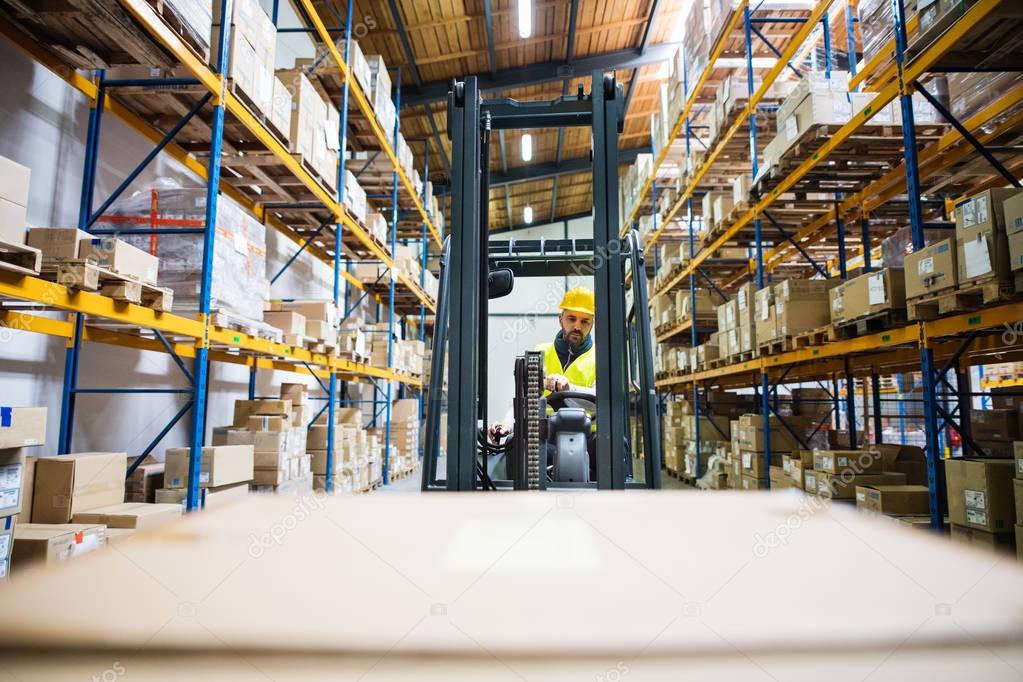 Warehouse man worker with forklift.