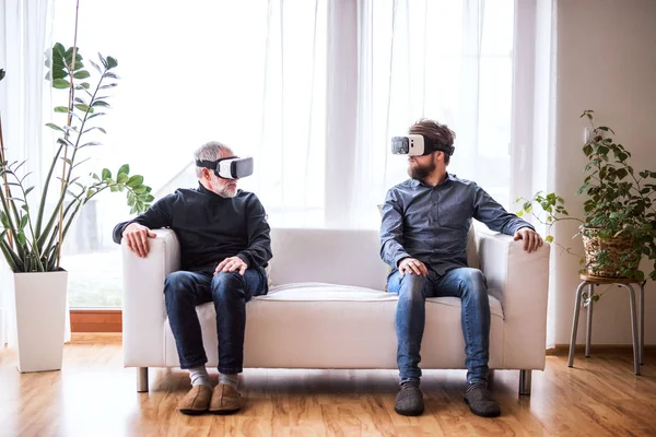 Hipster son and his senior father with VR goggles at home. — Stock Photo, Image