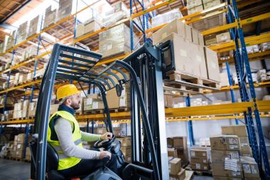 Forklift kullanan bir depocu..