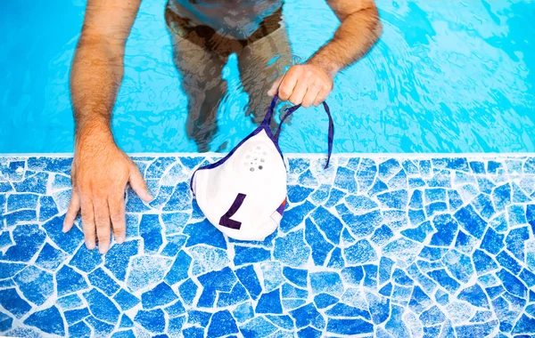 Onherkenbaar waterpoloër in een zwembad. — Stockfoto