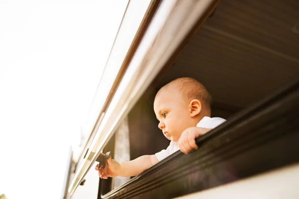 Baby boy in a camper van. — Stock Photo, Image