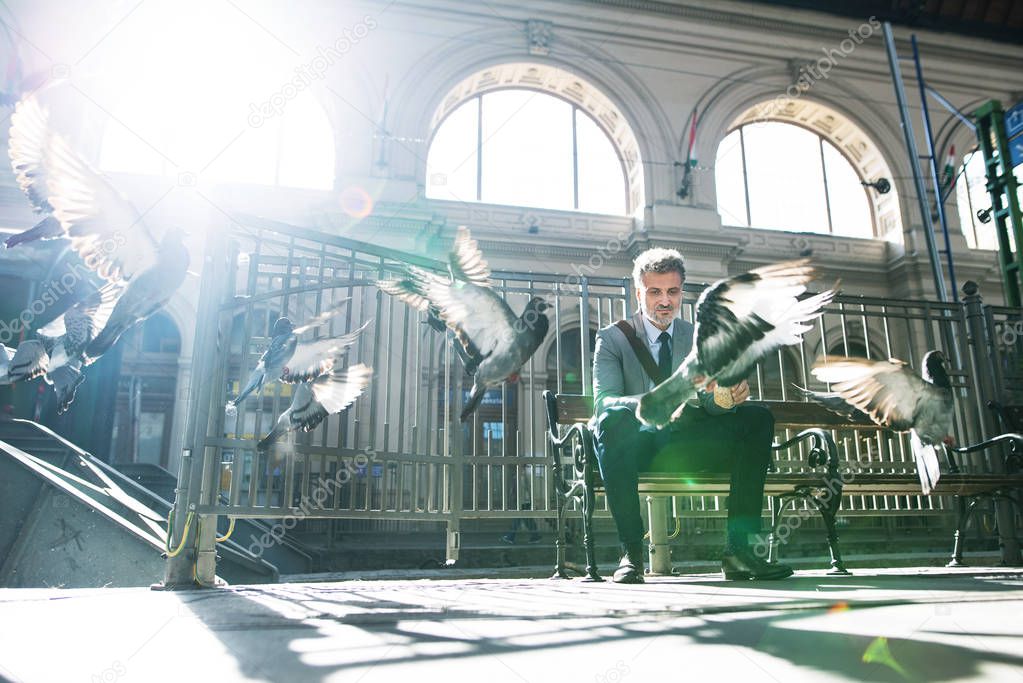 Mature businessman on a train station.