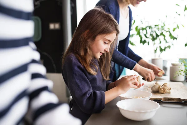 A small girl with mother and grandmother at home. — Stock Photo, Image