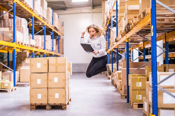 Overjoyed female worker or supervisor in a warehouse. — Stock Photo, Image
