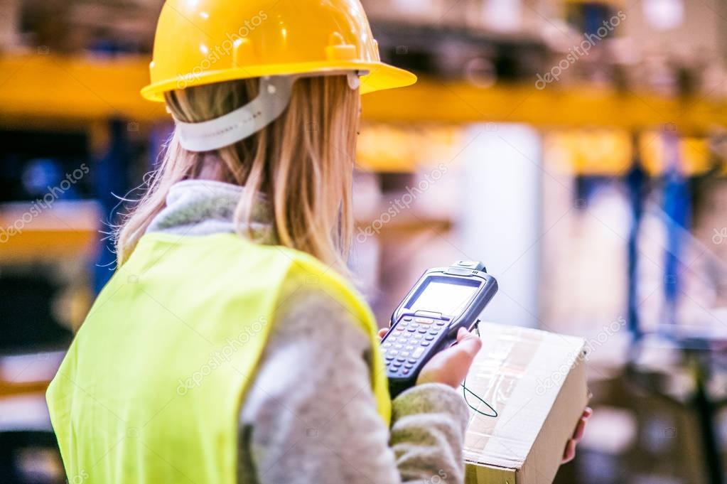 Warehouse woman worker with barcode scanner.