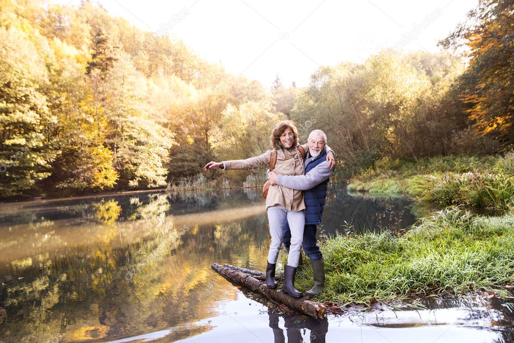 Senior couple on a walk in autumn nature.