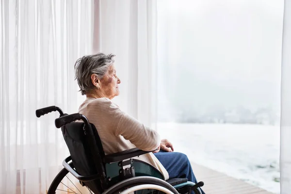 Senior woman in wheelchair at home. — Stock Photo, Image