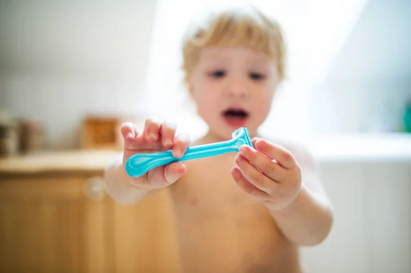 Toddler boy in dangerous situation at home. Child safety concept. — Stock Photo, Image