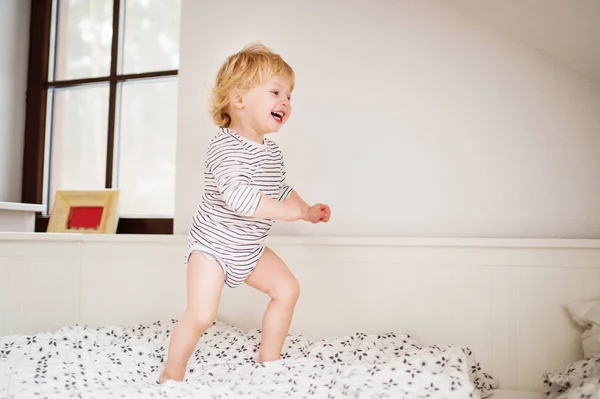 Cute toddler boy jumping on the bed. — Stock Photo, Image