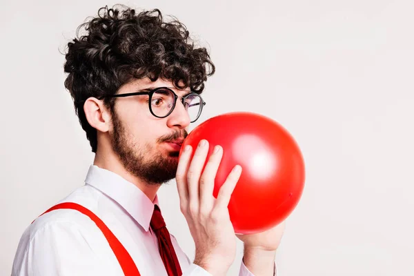 Portrait of a young man with balloon in a studio. — Stock Photo, Image
