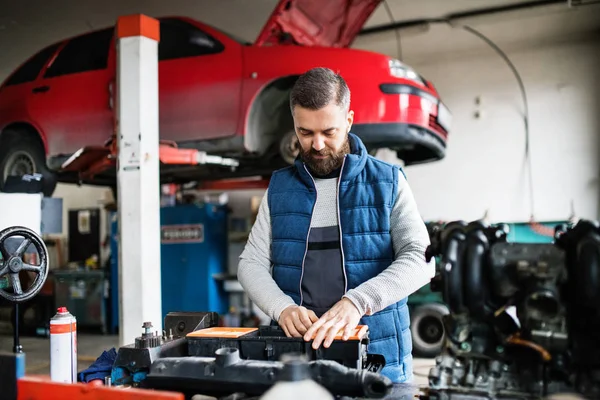 Man mechanic repairing a car in a garage. — Stock Photo, Image