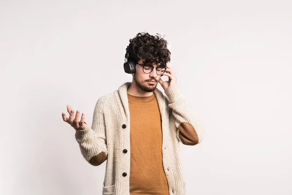 Portret van een jonge man met een koptelefoon in een studio. — Stockfoto