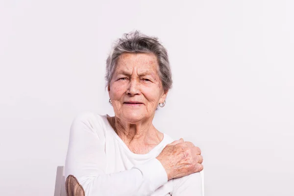 Retrato de estúdio de uma mulher idosa com dor . — Fotografia de Stock