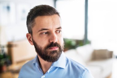 Evde yakışıklı bir adam portresi.