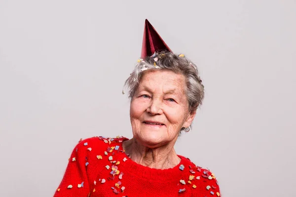 Ritratto di una donna anziana in studio. Concetto di partito . — Foto Stock