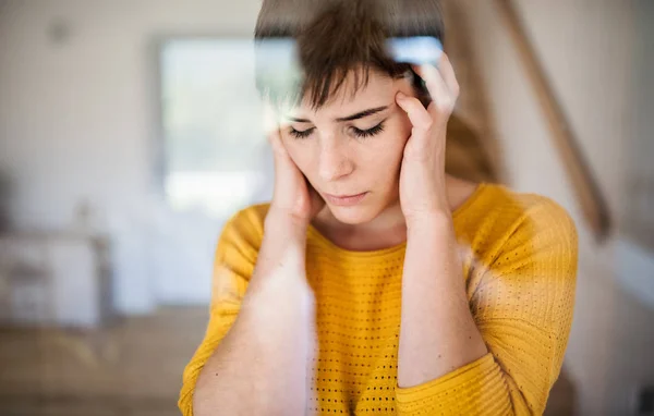 Front view of sad young woman standing indoors at home, close-up. — Stock Photo, Image