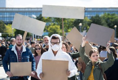 People with placards and protective suit on global strike for climate change. clipart