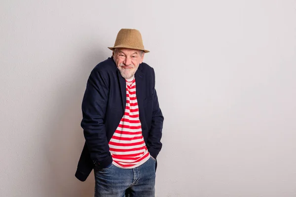 Front view portrait of a senior man with striped T-shirt in a studio. — 스톡 사진