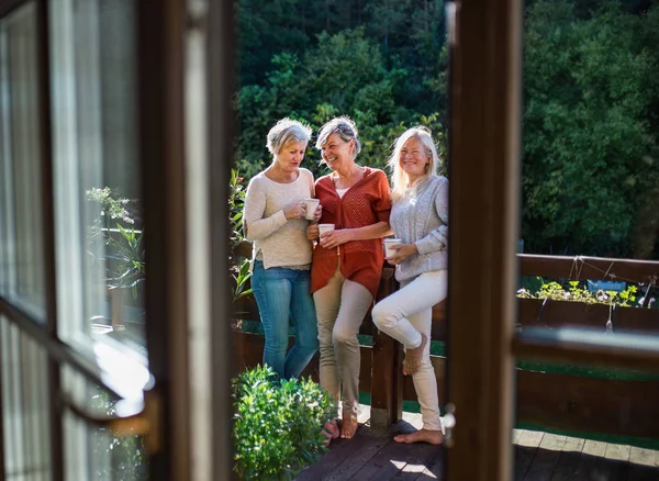 Senior women friends standing outdoors on terrace, resting. — Stock Photo, Image