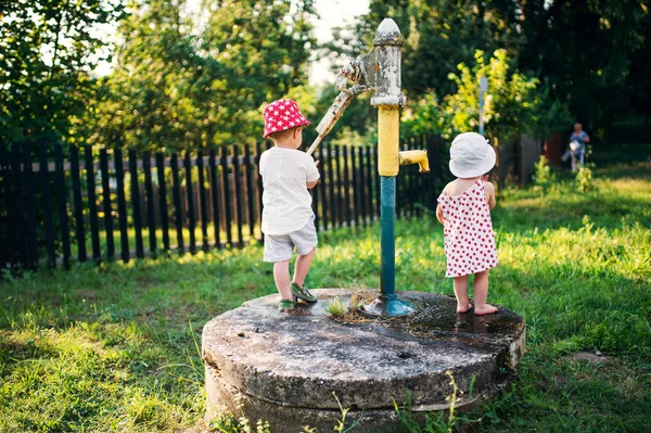 Widok z tyłu malucha dzieci stojących na zewnątrz w ogrodzie w lecie. — Zdjęcie stockowe