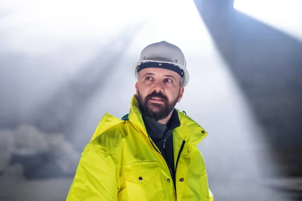 Mature man engineer standing on construction site. — Stock Photo, Image