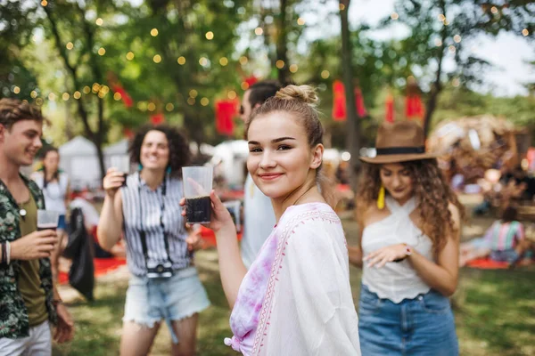 Groupe de jeunes amis avec des boissons au festival d'été, debout . — Photo